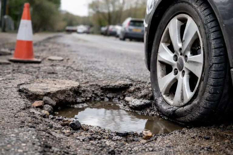 car tyre beside pothole in Gillingham road after impact damage