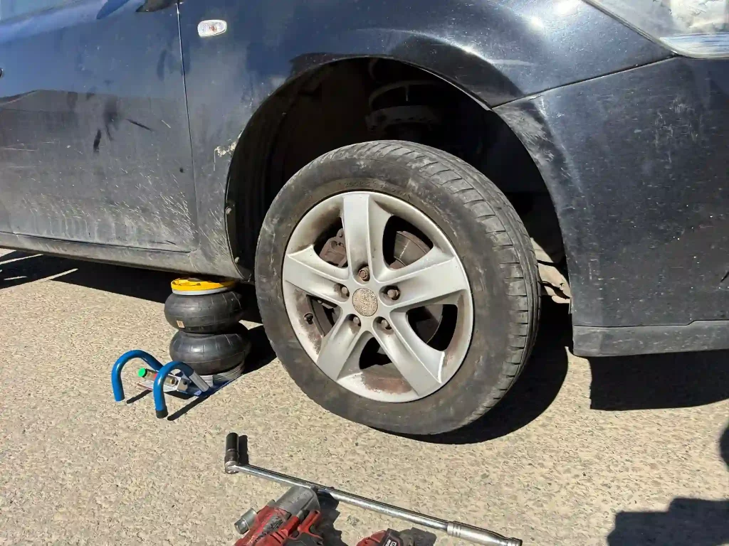 Mobile Tyre Replacement in Progress – Car Lifted for Wheel Change at Customer Location